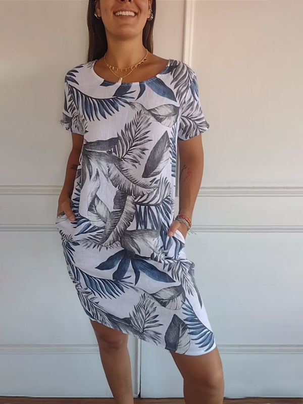Comfortable women's midi summer dress, featuring a stylish leaf print, short sleeves, and handy pockets. Perfect for casual wear.