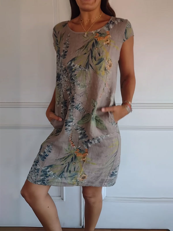 Elegant leaf print midi summer dress for women, with short sleeves, V-neck, and pockets, ideal as a casual vacation outfit.