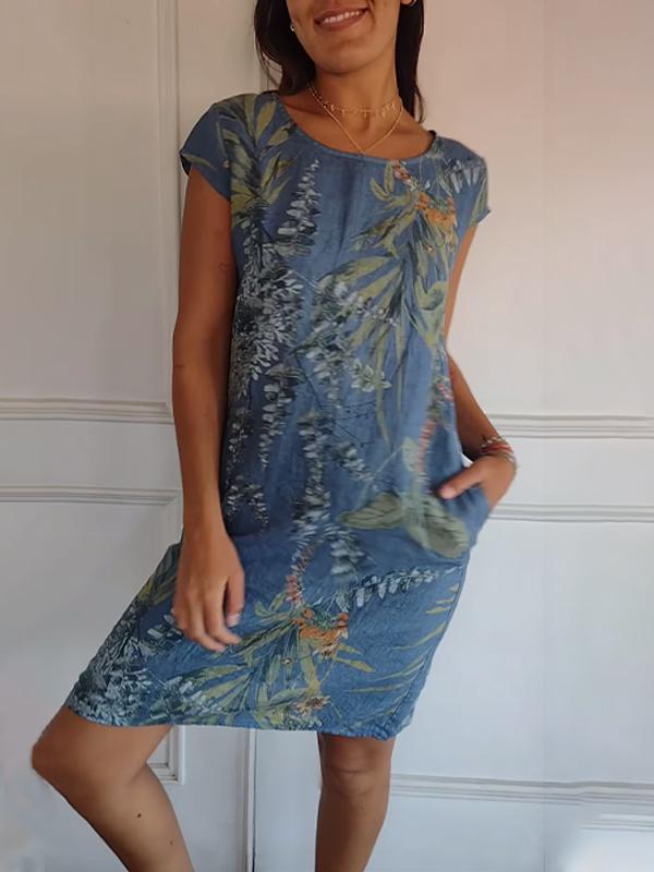 Women's V-neck midi summer dress, vibrant leaf print, short sleeves, and functional side pockets for a relaxed, casual look.