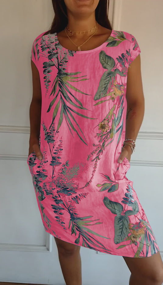 Casual women's short sleeve midi dress with a unique leaf print pattern and convenient pockets, great for summer comfort.