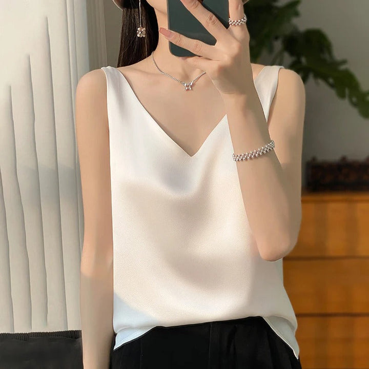 Loose casual women's sleeveless top featuring a plunging V-neck. Ideal for comfortable summer & spring fashion.