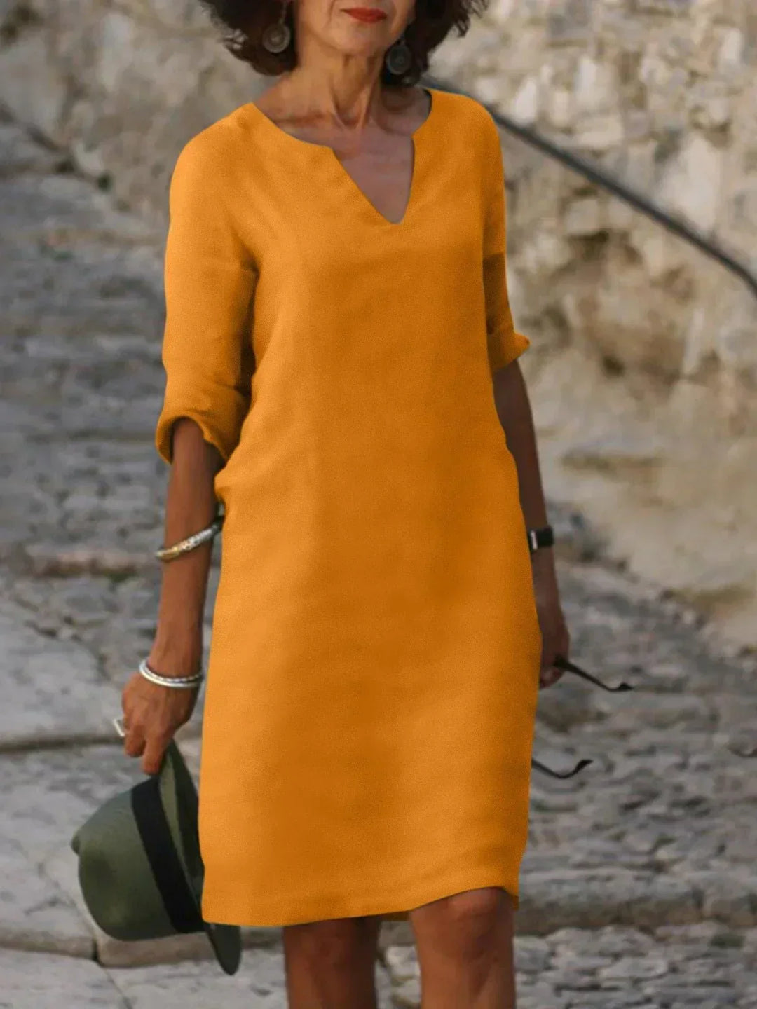 Flattering A-line women's V-neck dress with chic mid sleeves, combining comfort and elegance.