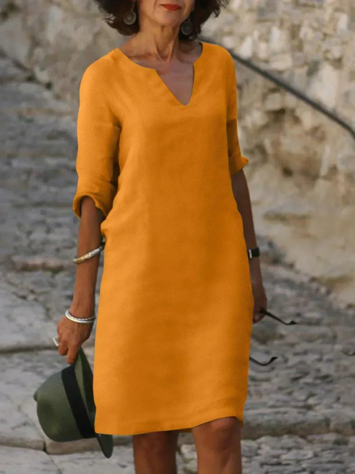 Stylish V-neck mini dress for women, 3/4 sleeves, casual loose fit, ideal for daily wear.