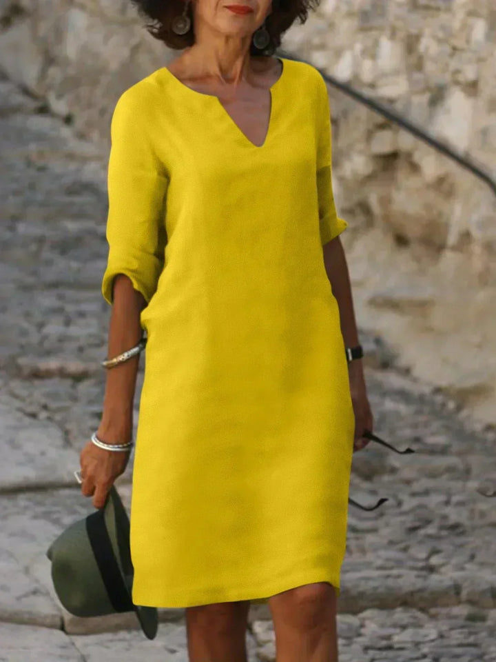 Comfy loose fit women's mini dress, 3/4 sleeves, V-neck, great for casual summer outings.