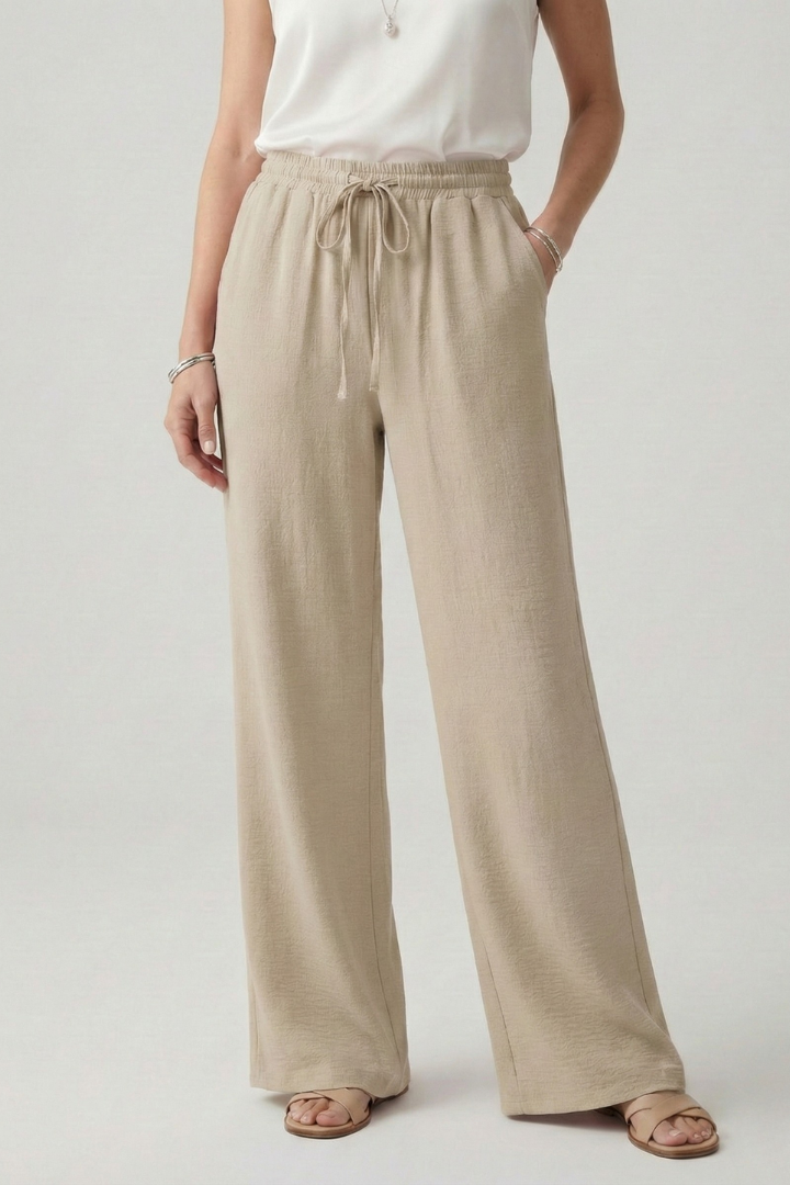 Women's casual palazzo trousers featuring a drawstring waist & wide leg. Comfy, everyday summer wear.