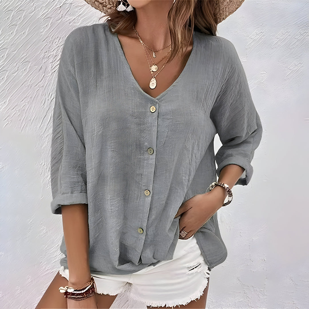 Relaxed fit women's blouse with roll sleeves & button-up front, a comfortable casual top for effortless style.