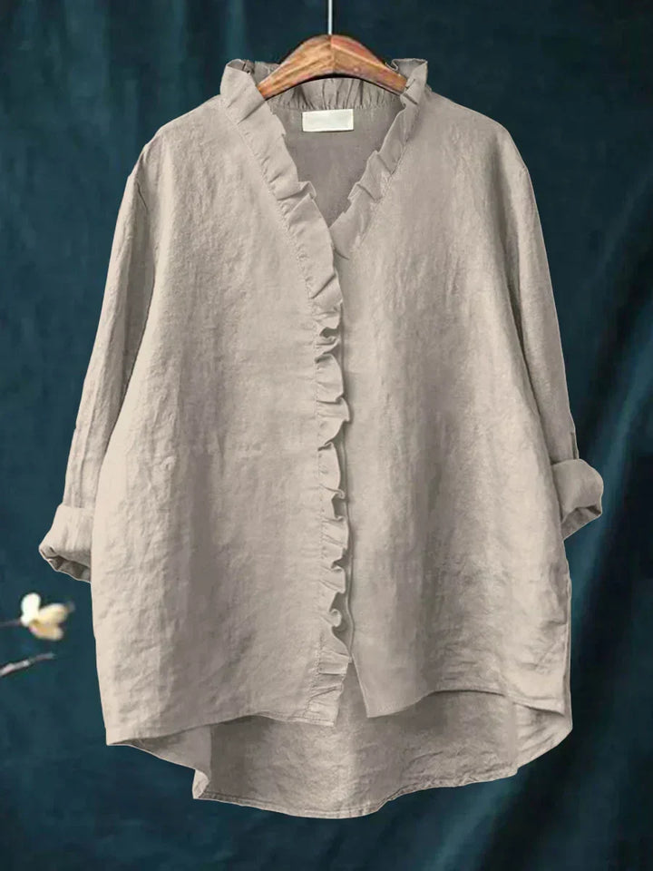 Women's long sleeve blouse with a flattering V-neck and pretty ruffle details.