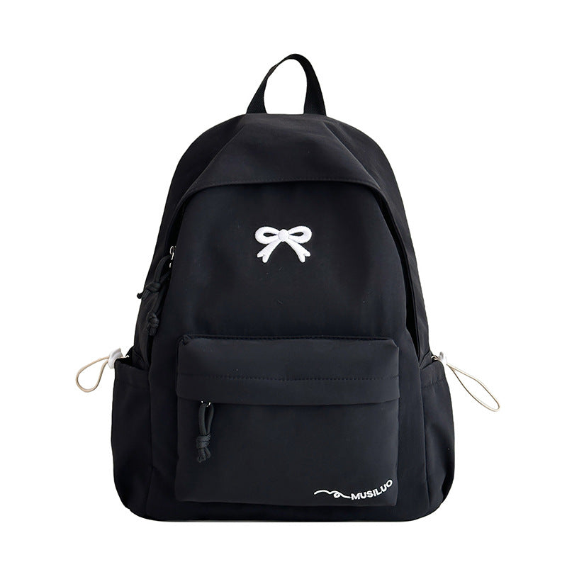 Chic bow-embossed women's school backpack, a fashionable and practical student bag for everyday wear.