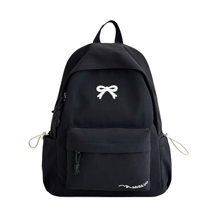 Chic bow-embossed women's school backpack, a fashionable and practical student bag for everyday wear.