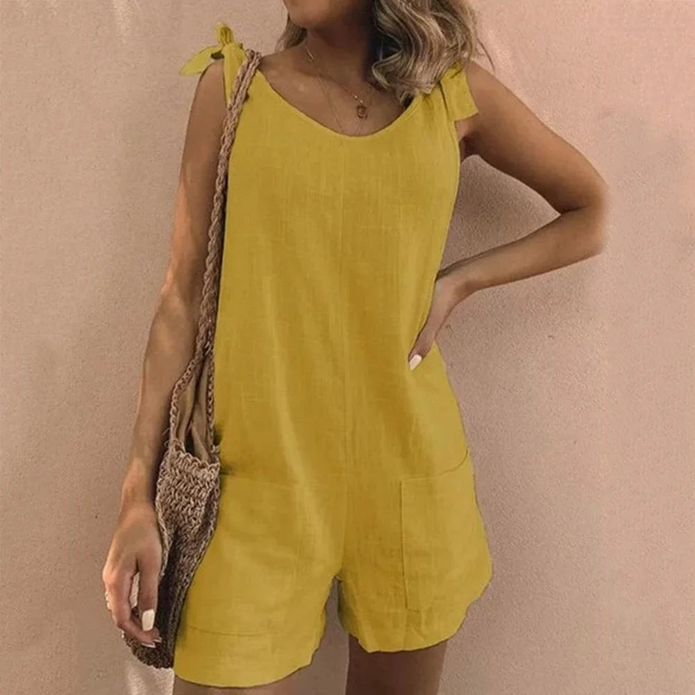 Comfortable women's one-piece short jumpsuit with adjustable bow-tie straps and handy pockets, ideal for casual days.