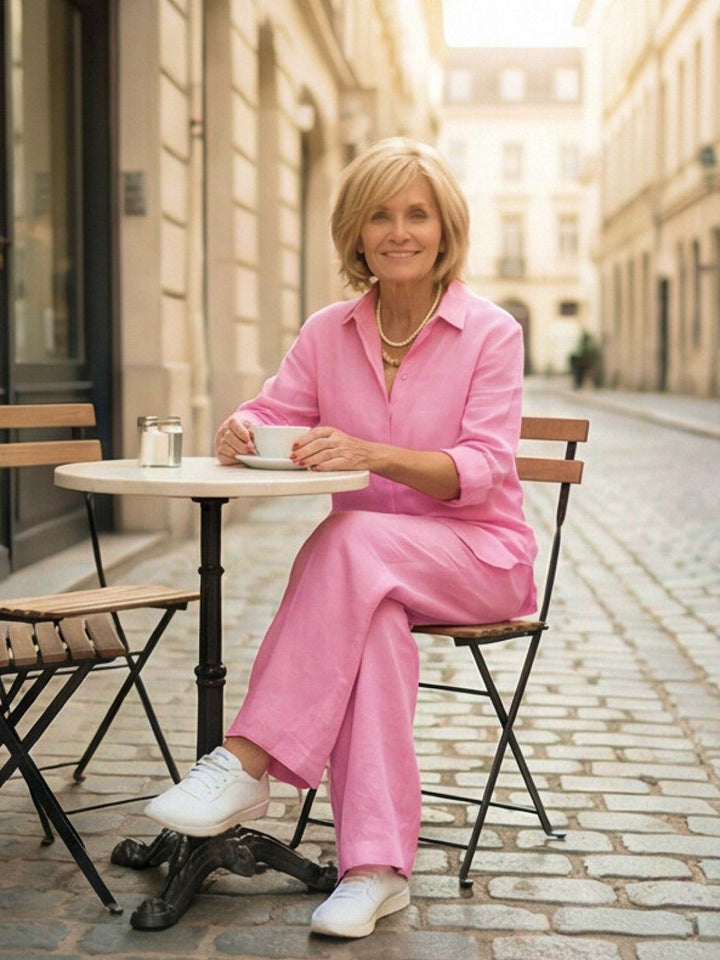 Studio shot of an elegant women's two-piece set: button-down shirt & wide-leg pants.