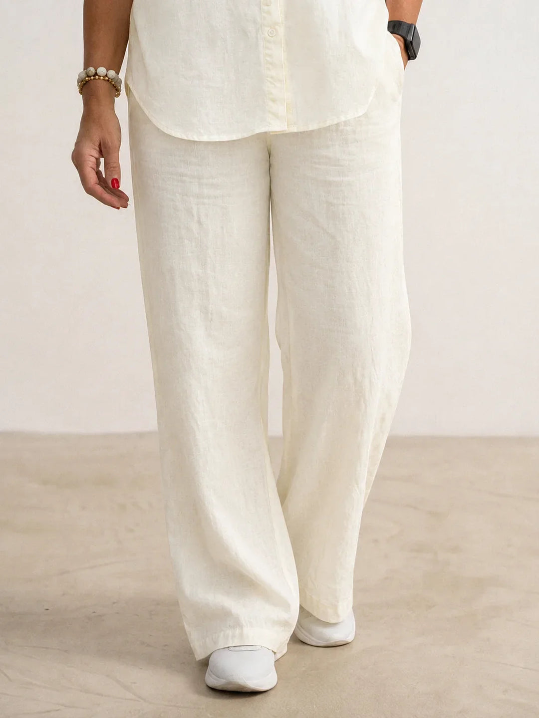 Women's two-piece outfit featuring a classic button-down shirt & modern wide-leg pants.