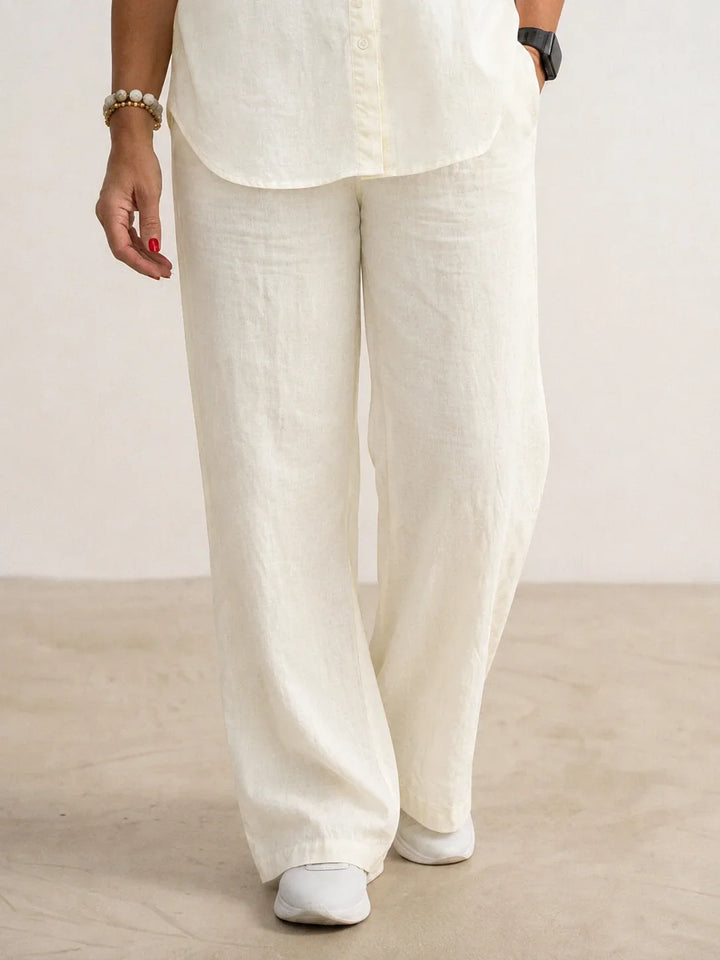 Women's two-piece outfit featuring a classic button-down shirt & modern wide-leg pants.