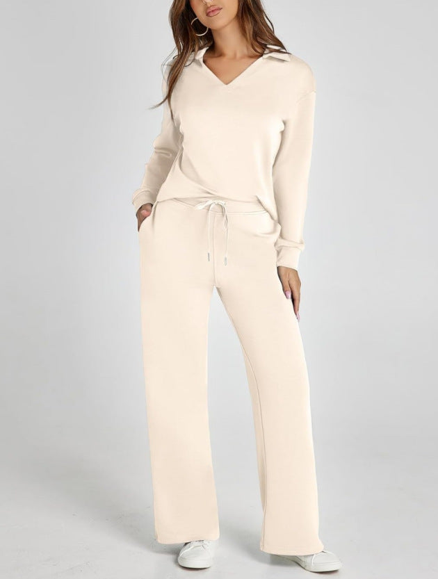 Close-up of women's casual zip-neck top, part of a two-piece wide-leg pants set. Comfy activewear style.
