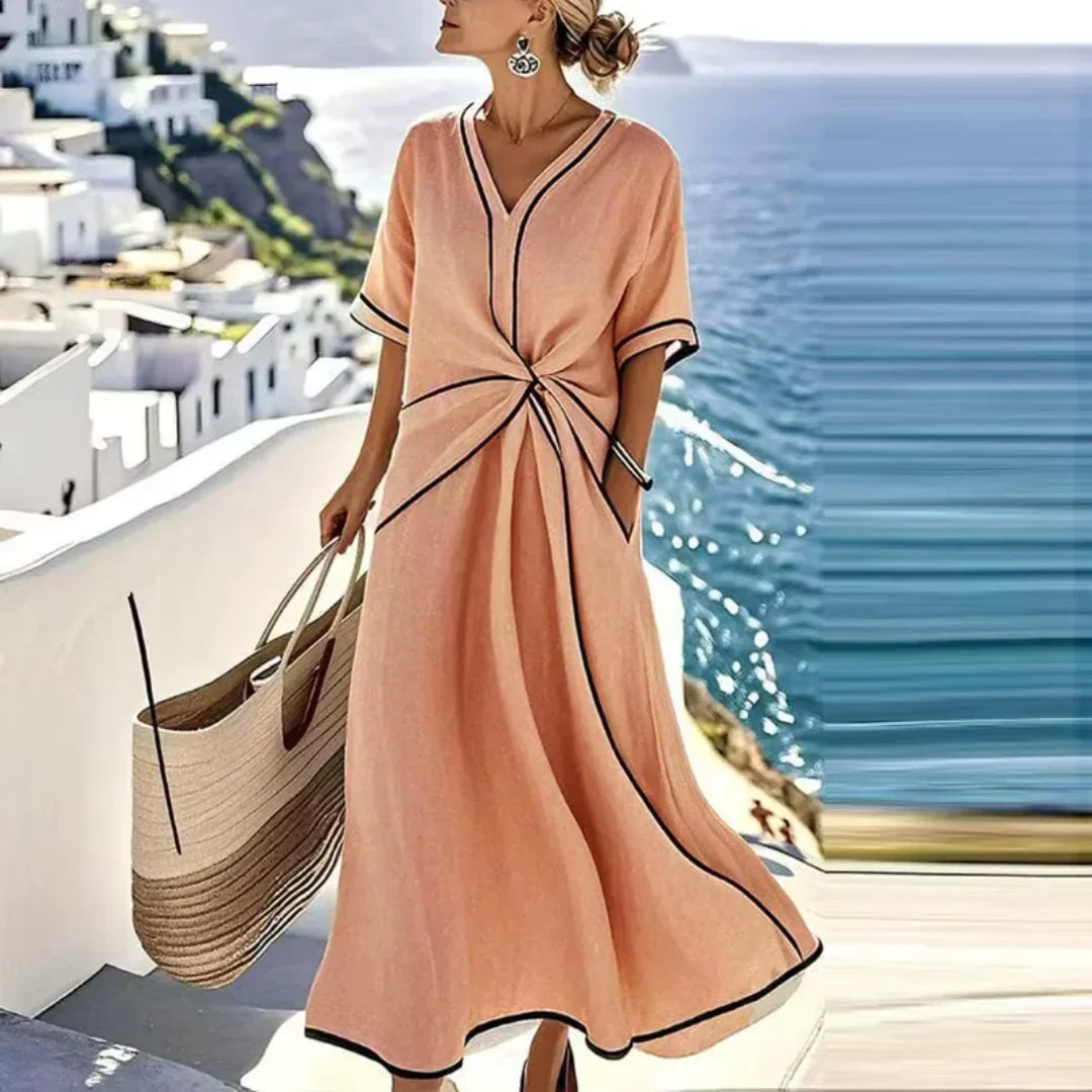 Relaxed fit women's V-neck midi dress with contrasting piping details and convenient pockets. Casual style.