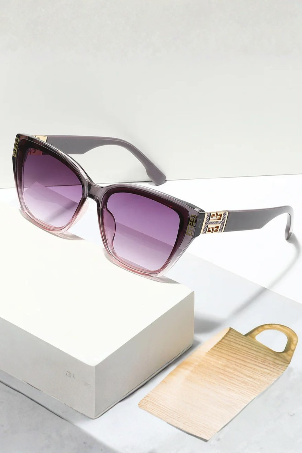 Fashion-forward women's cat eye sunglasses, gold detail, gradient lenses for a chic look.