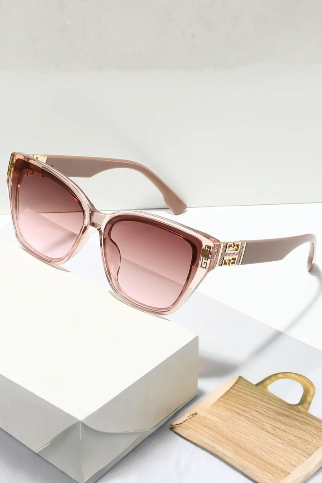 Glamorous women's cat eye sunglasses, gold trim, gradient lenses, a stylish eyewear choice.