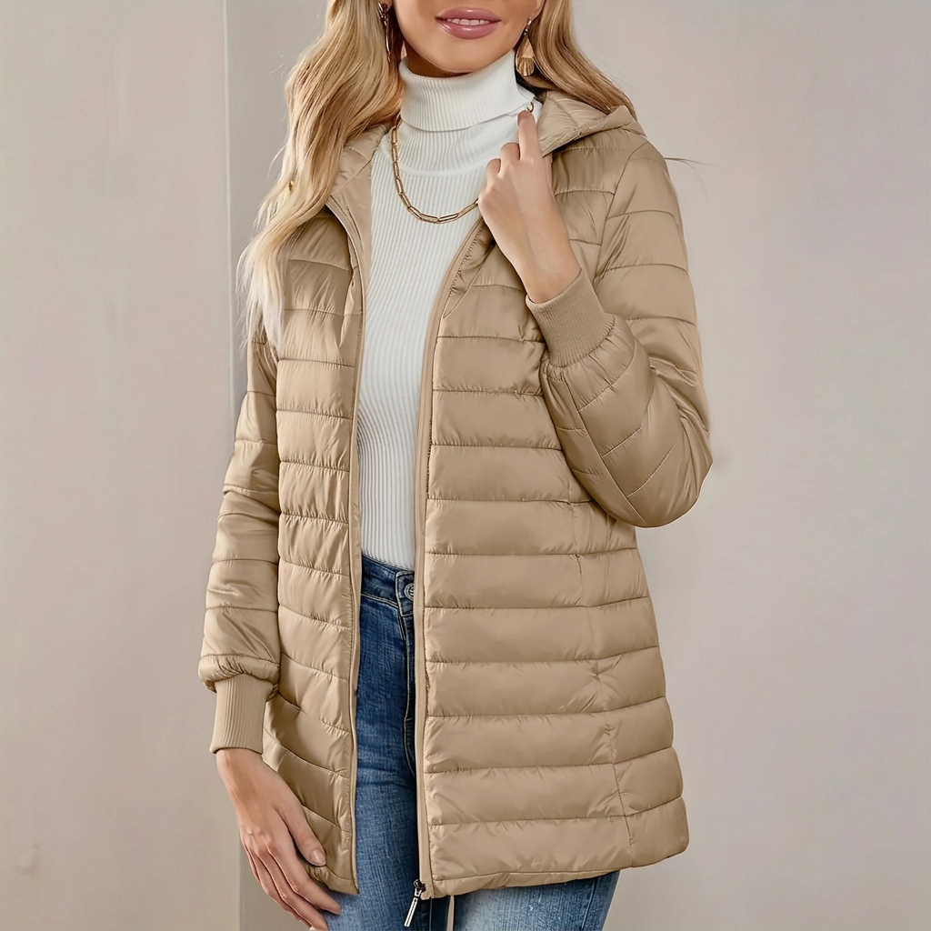 Stylish women's longline quilted jacket with hood, perfect lightweight outerwear for everyday casual wear.