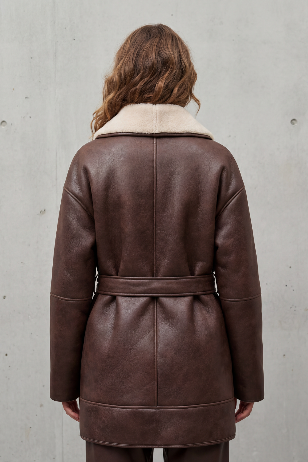 Chic women's fall fashion coat, belted for a flattering fit, with a cozy contrast collar. Ideal winter outerwear.