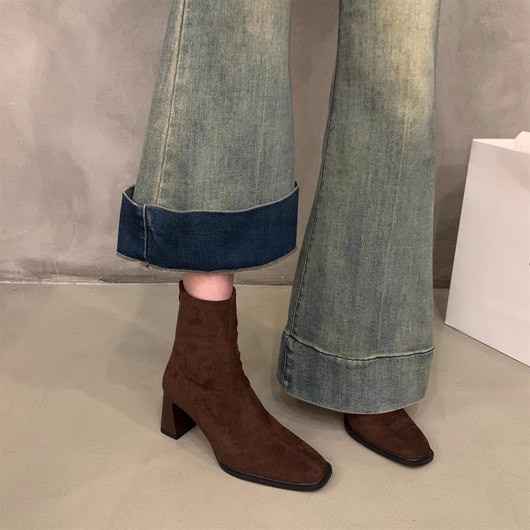 Stylish women's black block heel ankle boots. Perfect pointed toe footwear for elegant fall fashion and winter outfits.