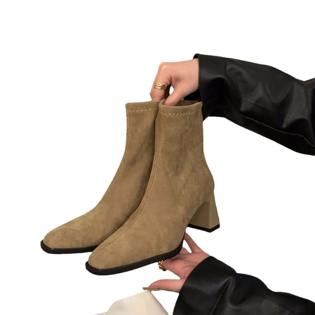 Fashionable women's elegant block heel ankle boots. Comfortable pointed toe design, ideal for chic fall and winter styles.