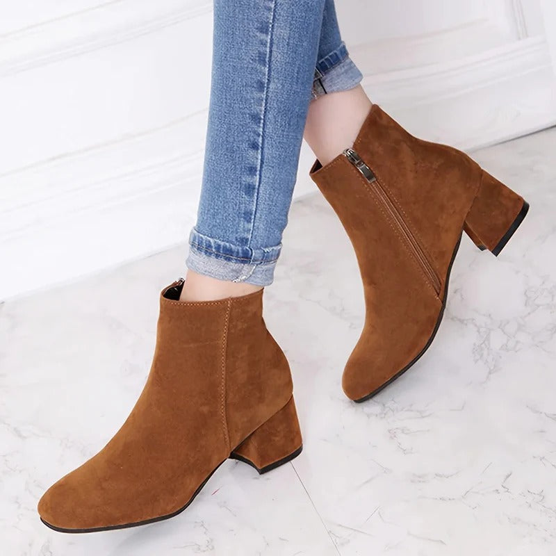 Women's chic block heel ankle boots with easy side zip for elegant, comfortable everyday wear.