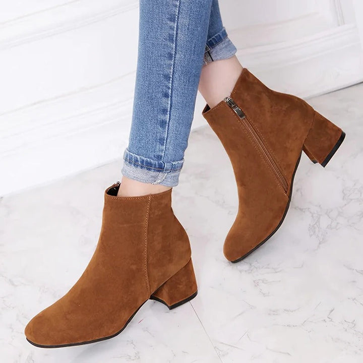 Women's chic block heel ankle boots with easy side zip for elegant, comfortable everyday wear.