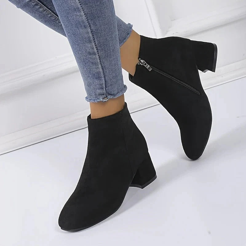Elegant ladies' block heel ankle boots feature a convenient side zip, ideal for chic fall/winter outfits.
