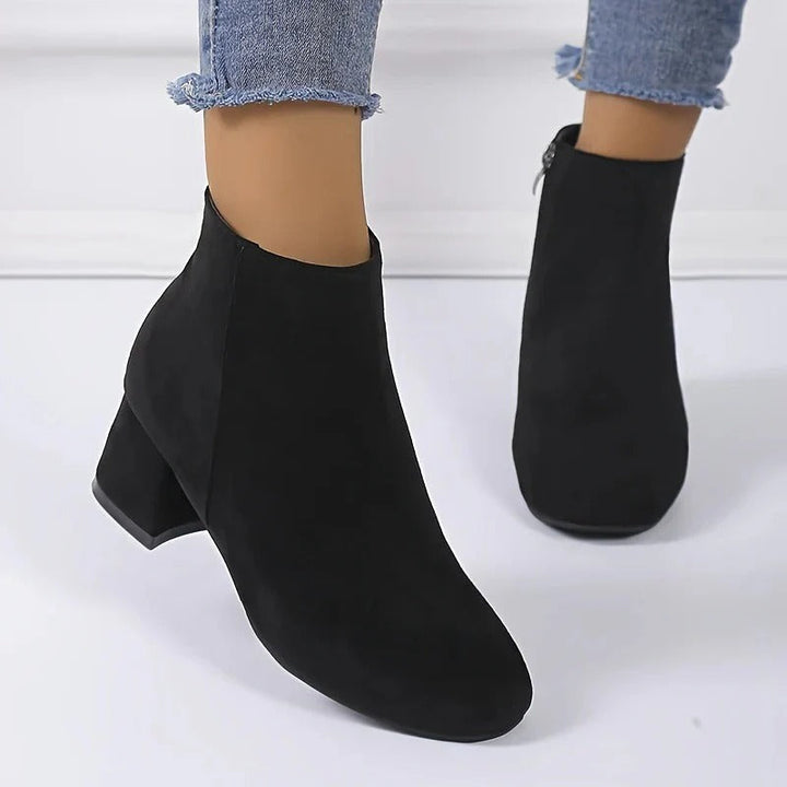 Fashionable women's block heel ankle boots with easy side zip, offering both style and comfort for any occasion.