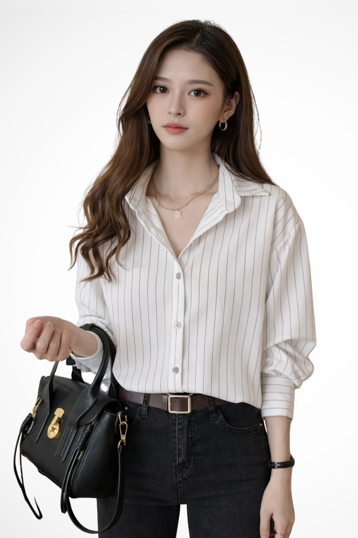 Classic blue and white striped long sleeve shirt for women. Versatile button-down blouse, a chic addition to any wardrobe.