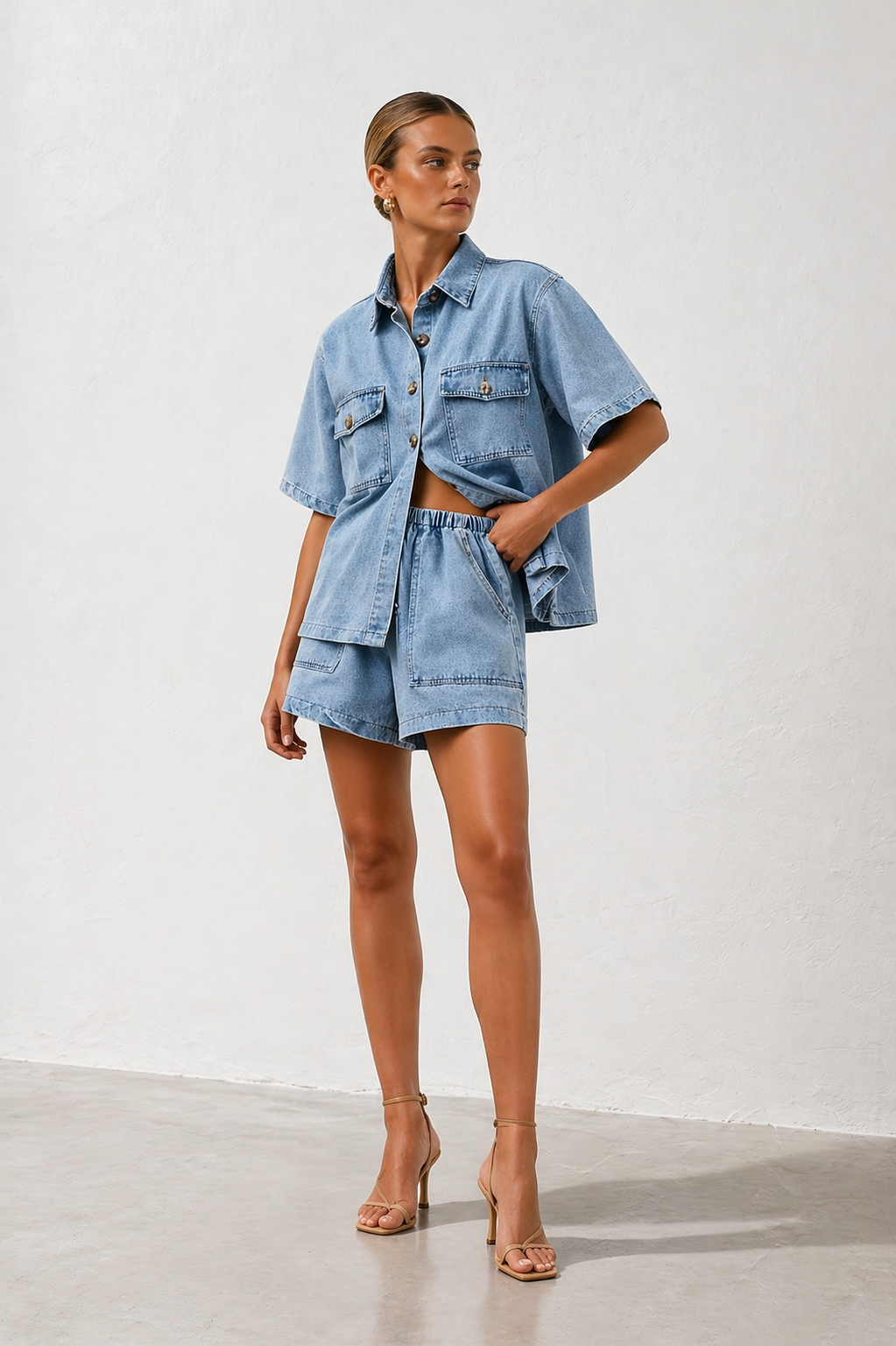 Chic women's blue two-piece set: a trendy shirt paired with comfortable high-waist shorts for versatile summer style.