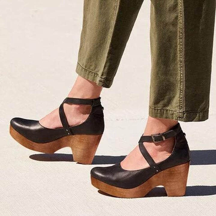 Women's chic closed-toe wedge heels with elegant ankle strap, perfect for versatile day to night wear.