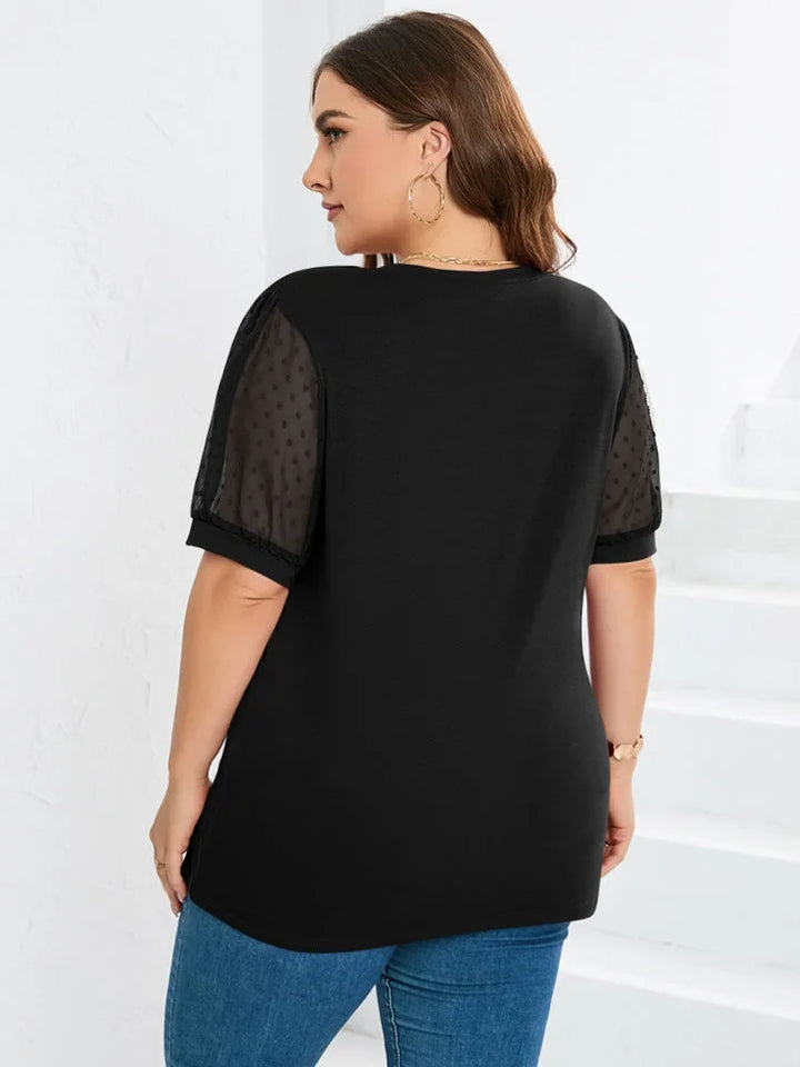 Versatile women's dotted top featuring a V-neck and trendy puff sleeves.