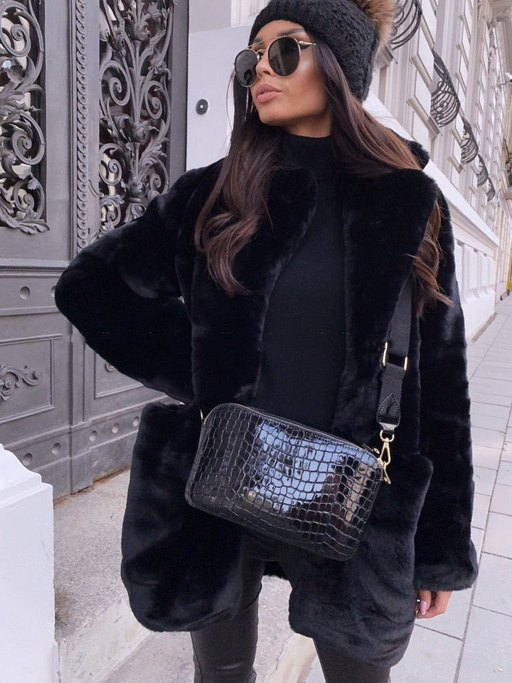 Elegant women's faux fur winter coat. Stay warm and fashionable with this chic outerwear jacket.