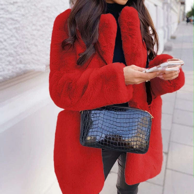 Warm women's faux fur coat. This stylish jacket is an elegant winter outerwear essential.