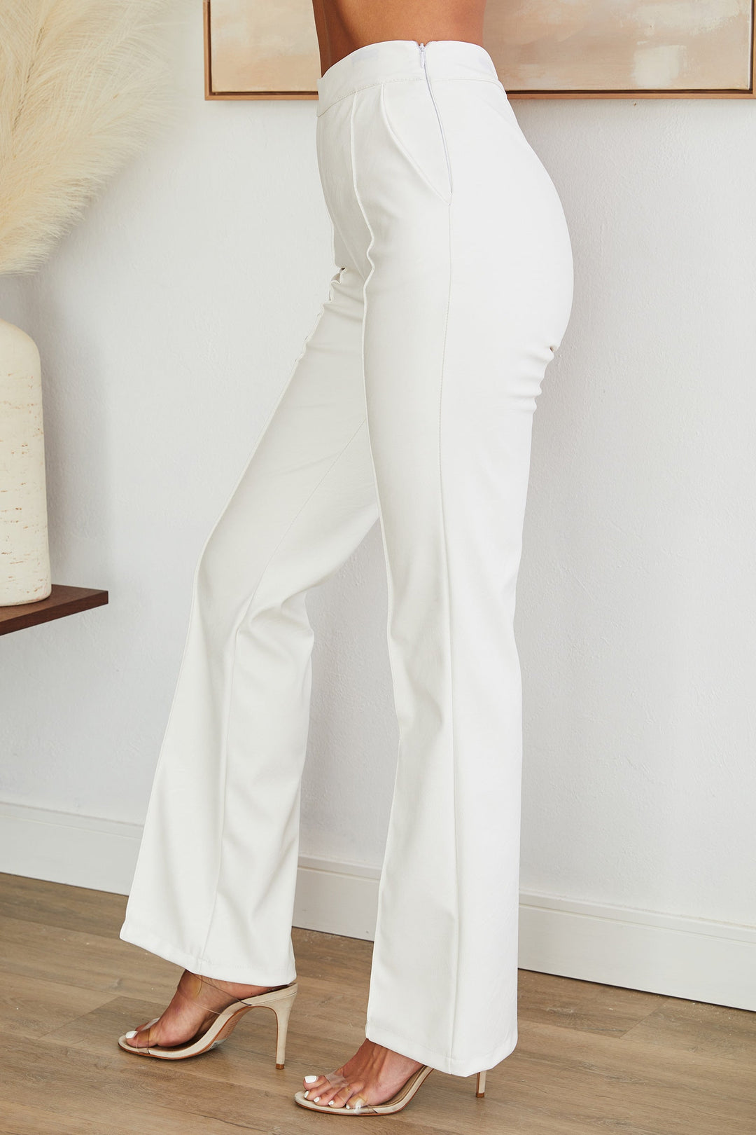 Stylish women's faux leather straight leg pants, featuring a side zip closure.