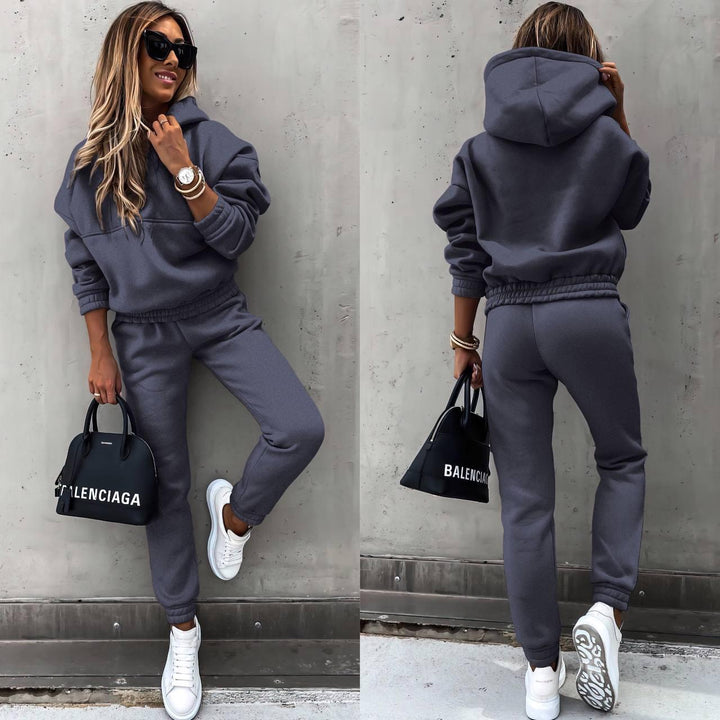 Soft grey women's loungewear set, featuring a chic sweatshirt and matching joggers for ultimate comfort.