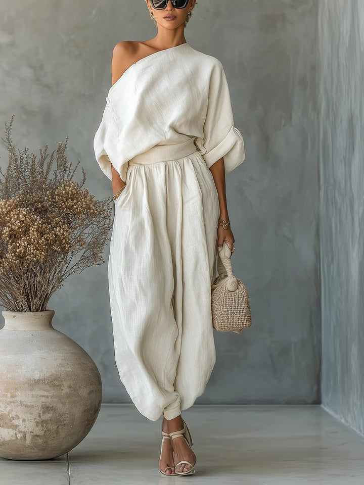 Women's chic off-shoulder top and tapered trousers set, perfect for elegant summer casual wear.