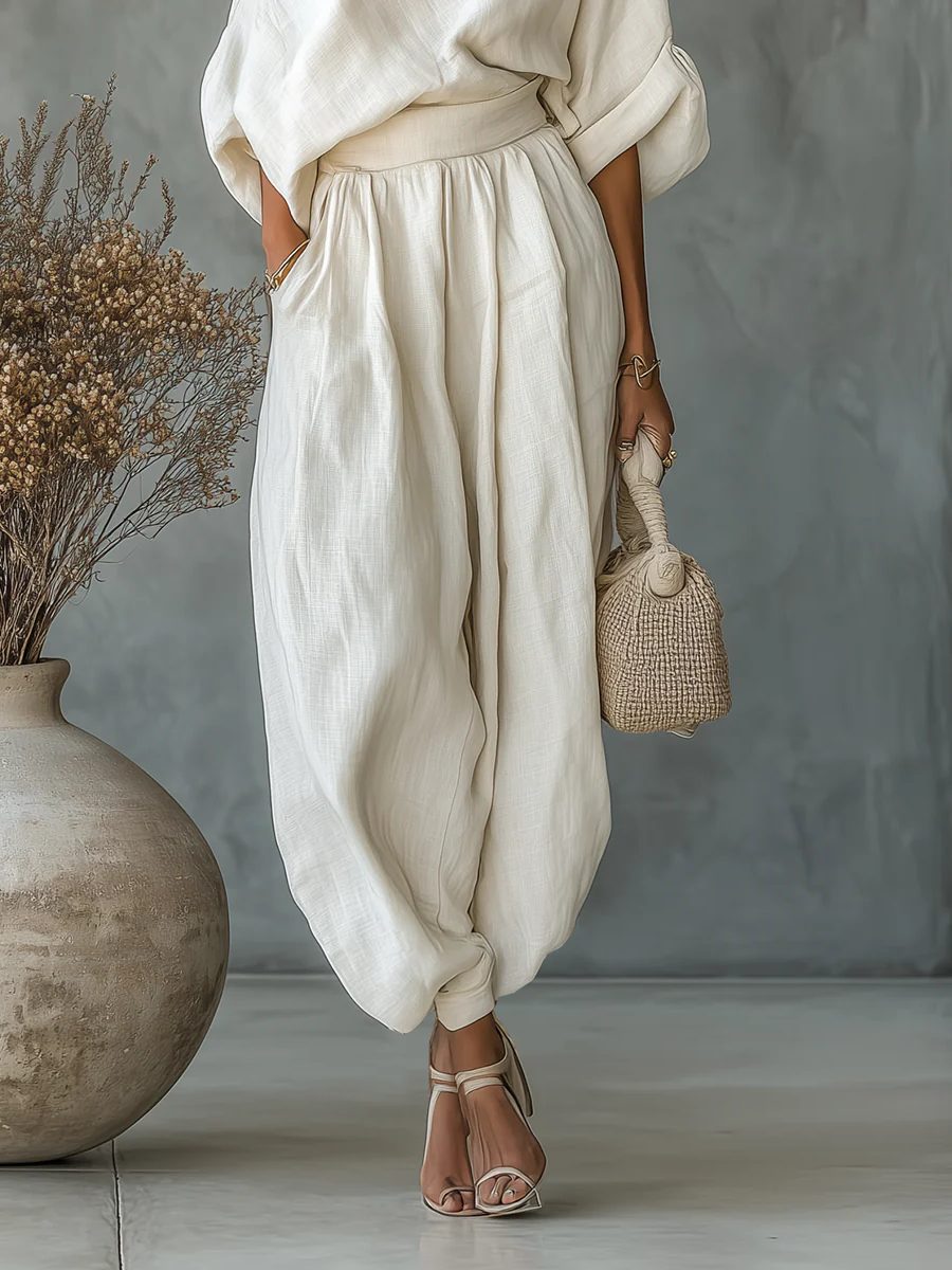 Elegant women's off-shoulder top and tapered pant set, a stylish two-piece outfit for modern summer fashion.