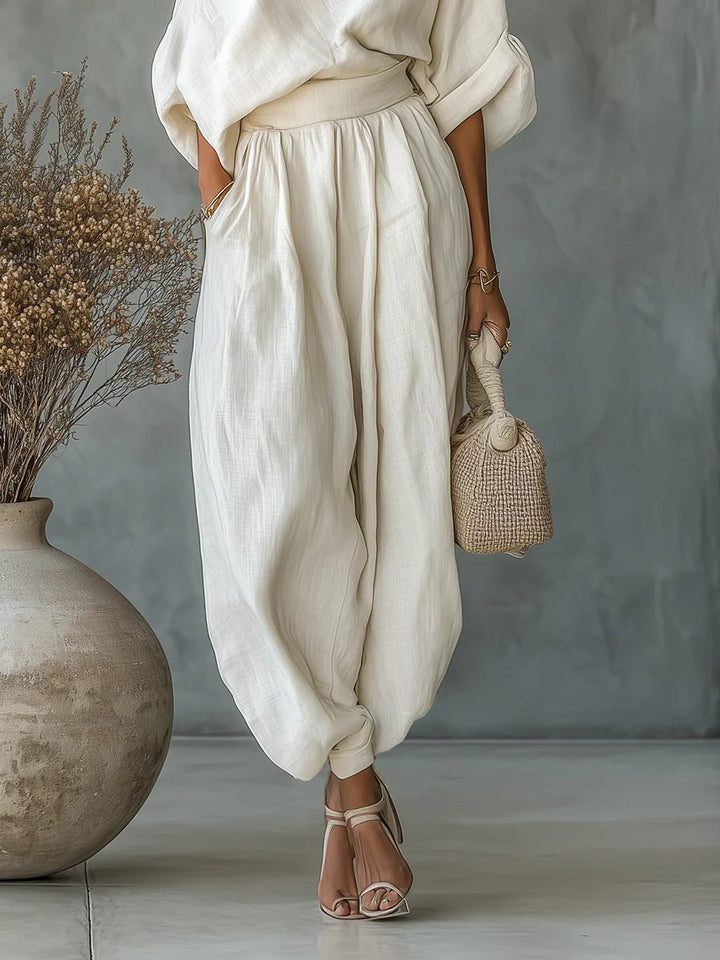 Elegant women's off-shoulder top and tapered pant set, a stylish two-piece outfit for modern summer fashion.
