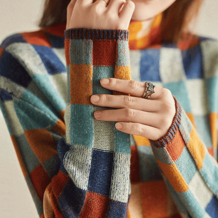 Cozy orange patchwork turtleneck sweater for women, perfect for stylish autumn outfits & winter fashion.