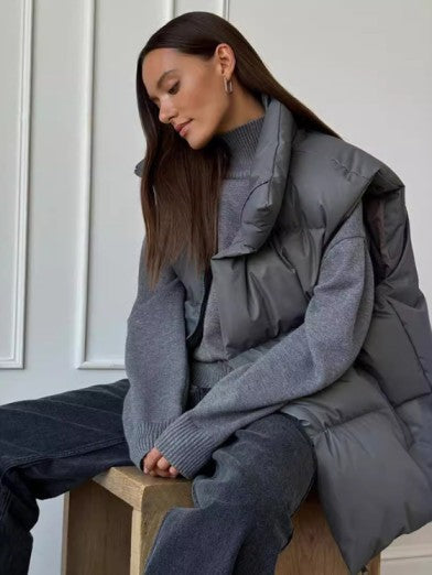 Women's chic puffer vest in black, sleeveless, perfect for winter layering & warmth. Trendy and versatile outerwear.