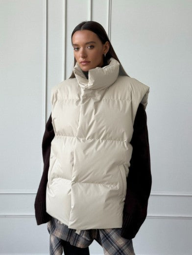 Stylish women's sleeveless puffer vest, ideal for cold weather fashion. Cozy, modern layering piece for casual wear.