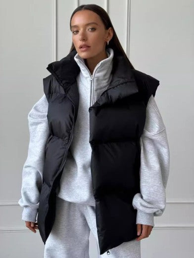 Elegant women's sleeveless puffer vest, providing essential winter warmth. Chic and versatile cold weather outerwear.