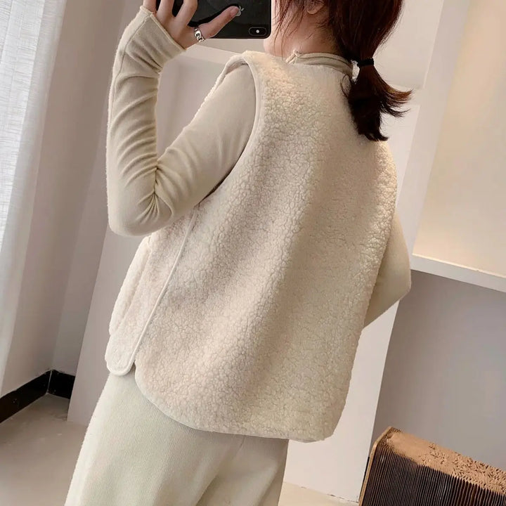 Casual women's sleeveless V-neck cardigan vest. Button-up layering top with convenient pockets.