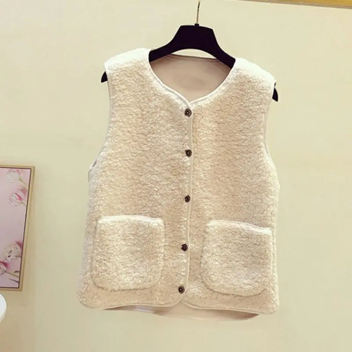 Womens V-neck sleeveless cardigan vest with button front closure & side pockets for autumn layering.