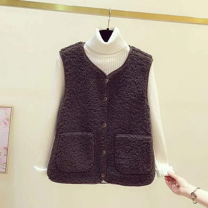 Versatile women's chic sleeveless V-neck cardigan vest. Button-front, relaxed fit, pockets.