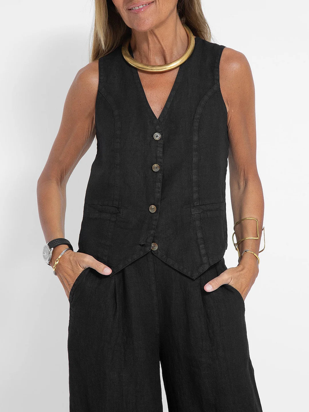 Woman showcasing a chic sleeveless V-neck wide-leg trouser set with confidence.