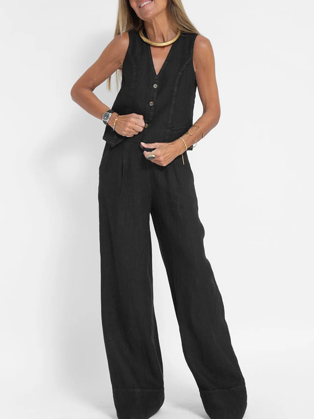 Close-up of the elegant V-neckline on a women's sleeveless wide-leg trouser set.