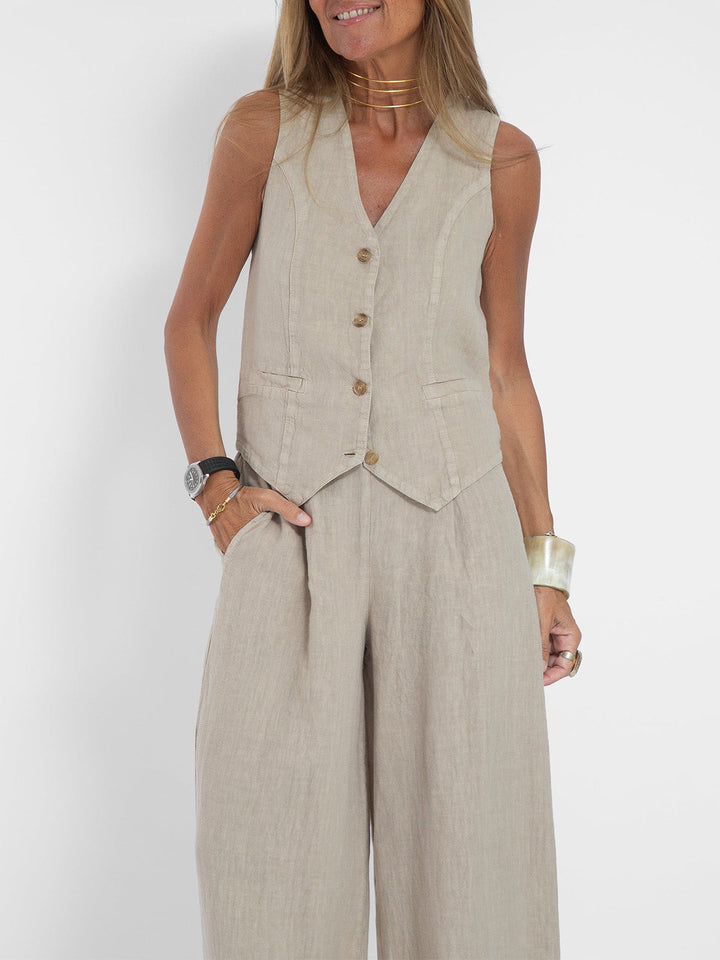 Flowing wide-leg trousers from a women's chic sleeveless V-neck two-piece set.